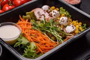 Fresh juicy salad with meat, mozzarella, carrots, lettuce, corn photo