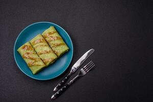 Spinach Crepes stuffed with chicken, mushrooms, salt and spices photo