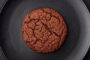 Delicious crispy round oatmeal cookies with chocolate photo