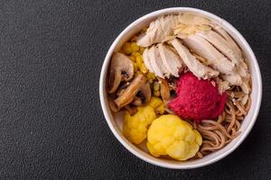 Asian dish with sliced chicken fillet, buckwheat noodles, soy sauce photo