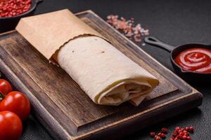 Delicious traditional shawarma or doner kebab with chicken photo