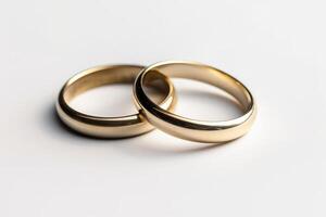 Two gold wedding rings on a white background photo