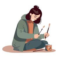 A woman is sitting on the ground with a paintbrush vector