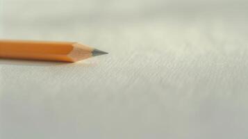 Sharp Yellow Pencil on Blank White Textured Paper - Minimalist Creative Workspace, Education and Writing Concept, Close-Up Focus photo