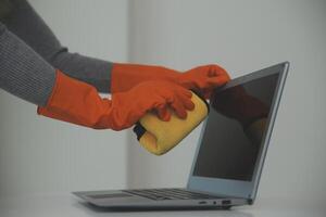 Woman cleaning table using rag and diffuser at home. photo