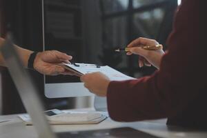 Cropped image of professional businesswoman working at her office via laptop, young female manager using portable computer device while sitting at modern loft, flare light, work process concept photo