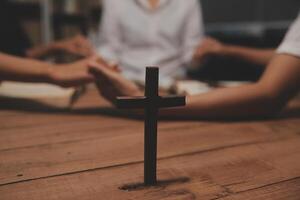 Christian group are praying to god with the bible and sharing the gospel. Concept of faith for god. photo