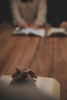 Christian group are praying to god with the bible and sharing the gospel. Concept of faith for god. photo