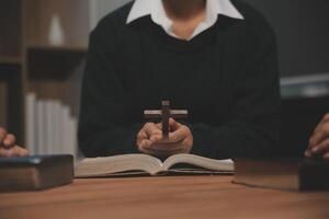 Christian group are praying to god with the bible and sharing the gospel. Concept of faith for god. photo