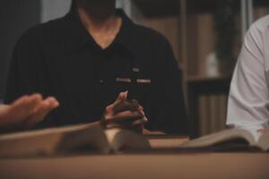 Christian group are praying to god with the bible and sharing the gospel. Concept of faith for god. photo