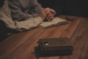 Christian group are praying to god with the bible and sharing the gospel. Concept of faith for god. photo