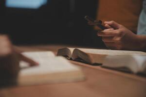 Christian group are praying to god with the bible and sharing the gospel. Concept of faith for god. photo