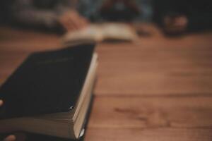 Christian group are praying to god with the bible and sharing the gospel. Concept of faith for god. photo