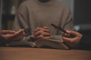 Christian group are praying to god with the bible and sharing the gospel. Concept of faith for god. photo