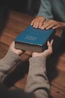 Christian group are praying to god with the bible and sharing the gospel. Concept of faith for god. photo