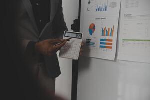 Close up of Business team analyzing income charts and graphs with modern laptop computer. Business analysis and strategy concept. photo