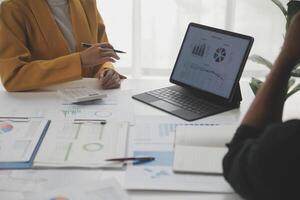 Close up of Business team analyzing income charts and graphs with modern laptop computer. Business analysis and strategy concept. photo