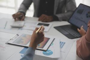 Close up of Business team analyzing income charts and graphs with modern laptop computer. Business analysis and strategy concept. photo