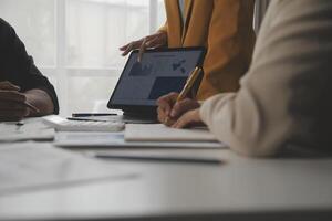 Close up of Business team analyzing income charts and graphs with modern laptop computer. Business analysis and strategy concept. photo
