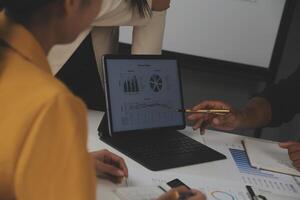 Close up of Business team analyzing income charts and graphs with modern laptop computer. Business analysis and strategy concept. photo