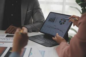 Close up of Business team analyzing income charts and graphs with modern laptop computer. Business analysis and strategy concept. photo