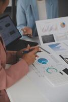 Close up of Business team analyzing income charts and graphs with modern laptop computer. Business analysis and strategy concept. photo