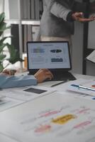 Close up of Business team analyzing income charts and graphs with modern laptop computer. Business analysis and strategy concept. photo