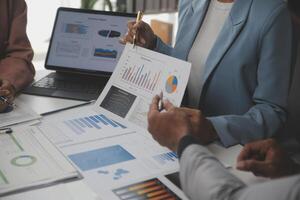 Close up of Business team analyzing income charts and graphs with modern laptop computer. Business analysis and strategy concept. photo