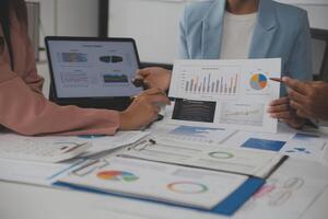 Close up of Business team analyzing income charts and graphs with modern laptop computer. Business analysis and strategy concept. photo