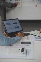 Close up of Business team analyzing income charts and graphs with modern laptop computer. Business analysis and strategy concept. photo