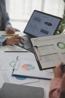 Close up of Business team analyzing income charts and graphs with modern laptop computer. Business analysis and strategy concept. photo