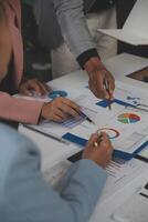 Close up of Business team analyzing income charts and graphs with modern laptop computer. Business analysis and strategy concept. photo