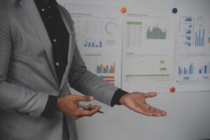 Close up of Business team analyzing income charts and graphs with modern laptop computer. Business analysis and strategy concept. photo
