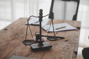 Judge gavel with Justice lawyers having team meeting at law firm background. Concepts of Law and Legal services. photo