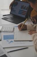 Close up of Business team analyzing income charts and graphs with modern laptop computer. Business analysis and strategy concept. photo