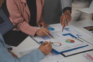 Close up of Business team analyzing income charts and graphs with modern laptop computer. Business analysis and strategy concept. photo
