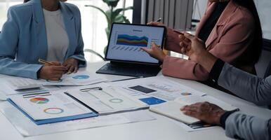 Close up of Business team analyzing income charts and graphs with modern laptop computer. Business analysis and strategy concept. photo