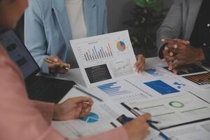 Close up of Business team analyzing income charts and graphs with modern laptop computer. Business analysis and strategy concept. photo