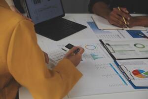 Close up of Business team analyzing income charts and graphs with modern laptop computer. Business analysis and strategy concept. photo