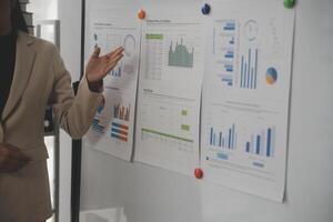 Close up of Business team analyzing income charts and graphs with modern laptop computer. Business analysis and strategy concept. photo
