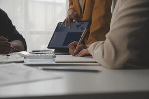 Close up of Business team analyzing income charts and graphs with modern laptop computer. Business analysis and strategy concept. photo