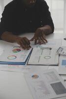 Close up of Business team analyzing income charts and graphs with modern laptop computer. Business analysis and strategy concept. photo