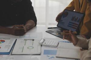 Close up of Business team analyzing income charts and graphs with modern laptop computer. Business analysis and strategy concept. photo