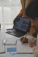 Close up of Business team analyzing income charts and graphs with modern laptop computer. Business analysis and strategy concept. photo