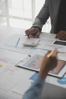 Close up of Business team analyzing income charts and graphs with modern laptop computer. Business analysis and strategy concept. photo