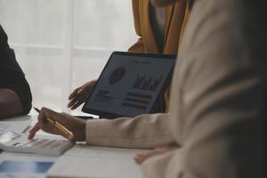 Close up of Business team analyzing income charts and graphs with modern laptop computer. Business analysis and strategy concept. photo