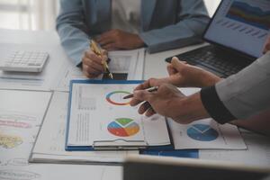Close up of Business team analyzing income charts and graphs with modern laptop computer. Business analysis and strategy concept. photo