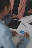 Close up of Business team analyzing income charts and graphs with modern laptop computer. Business analysis and strategy concept. photo