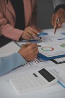 Close up of Business team analyzing income charts and graphs with modern laptop computer. Business analysis and strategy concept. photo