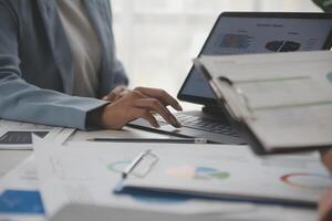 Close up of Business team analyzing income charts and graphs with modern laptop computer. Business analysis and strategy concept. photo